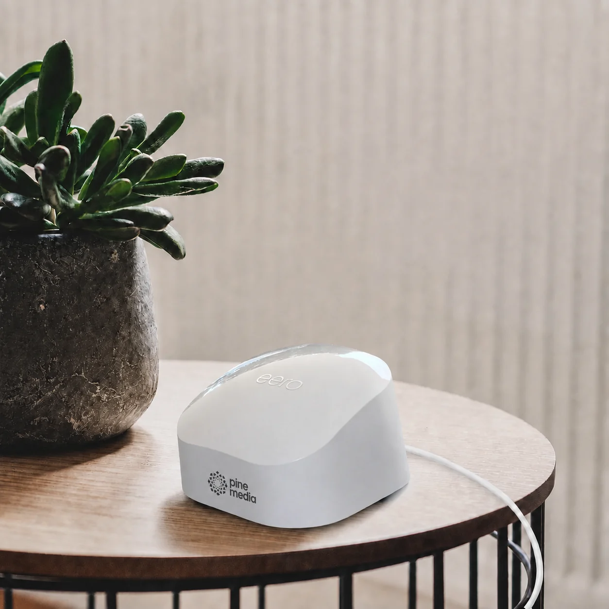 Pine Media branded eero 7 router on a table at home
