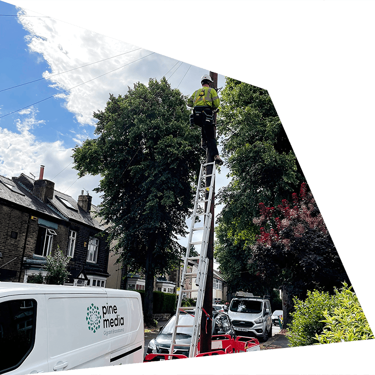 Engineer installing fibre on a telegraph pole